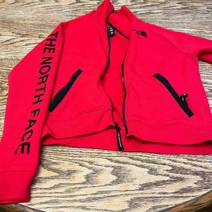 The North Face women’s jacket. Red with black lettering and zippers